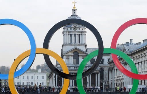 File photo shows giant Olympic Rings on a barge floating past the Old Naval College at Greenwich on the river Thames in London. Saudi Arabia, where sports events for women are banned, will allow females to compete in the Olympic Games for the first time