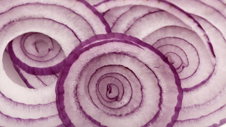 stacked sliced red onions 