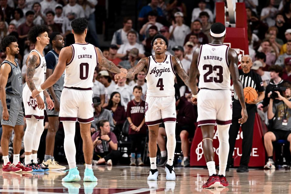 Nov 17, 2023; College Station, Texas, USA; Texas A&M Aggies guard <a class="link " href="https://sports.yahoo.com/ncaab/players/163969" data-i13n="sec:content-canvas;subsec:anchor_text;elm:context_link" data-ylk="slk:Wade Taylor IV;sec:content-canvas;subsec:anchor_text;elm:context_link;itc:0">Wade Taylor IV</a> (4) is high fives by teammates during the second half against the Oral Roberts Golden Eagles at Reed Arena. Mandatory Credit: Maria Lysaker-USA TODAY Sports