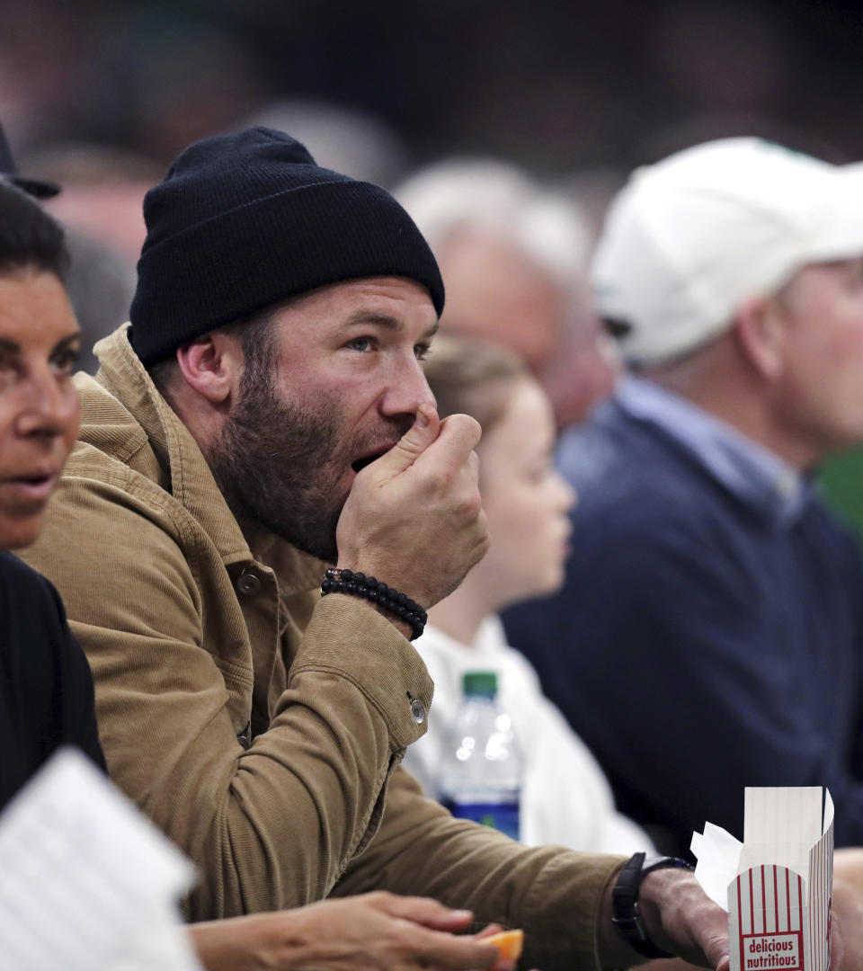 New England Patriots wide receiver Julian Edelman eats popcorn in the front row while watching the second quarter of Game 2 of an NBA basketball first-round playoff series between the Boston Celtics and Indiana Pacers, Wednesday, April 17, 2019, in Boston. (AP Photo/Charles Krupa)