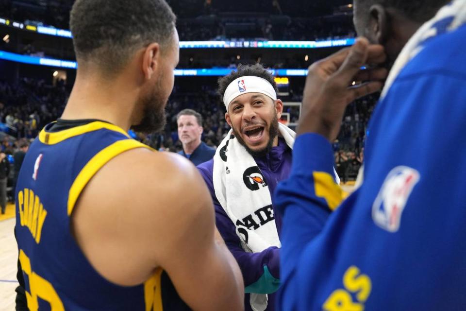 Feb 23, 2024; San Francisco, California, USA; Charlotte Hornets guard Seth Curry (center) talks with Golden State Warriors guard Stephen Curry (left) and forward Draymond Green (right) after the game at Chase Center. Mandatory Credit: Darren Yamashita-USA TODAY Sports