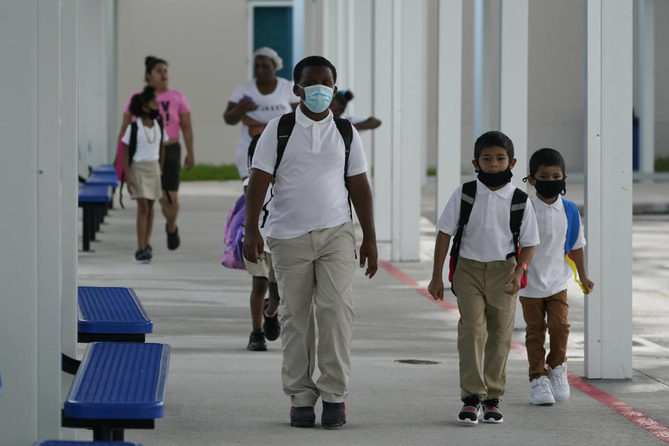 Children arrive, Tuesday, Aug. 10, 2021, for the first day of school at Washington Elementary School in Riviera Beach, Fla. (Wilfredo Lee/AP)  