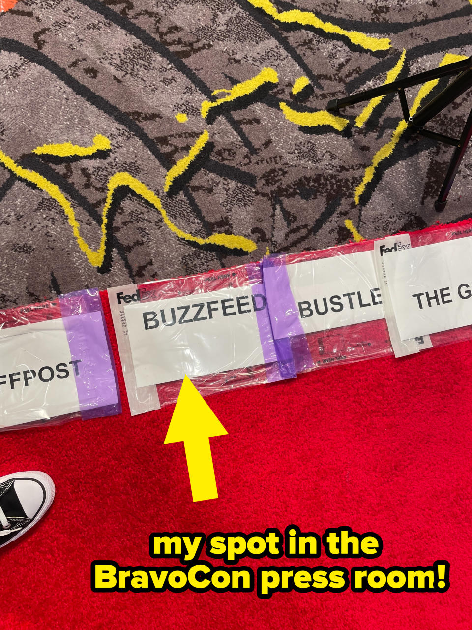 A shot of the author's feet on the red carpet displaying the "BuzzFeed" press sign