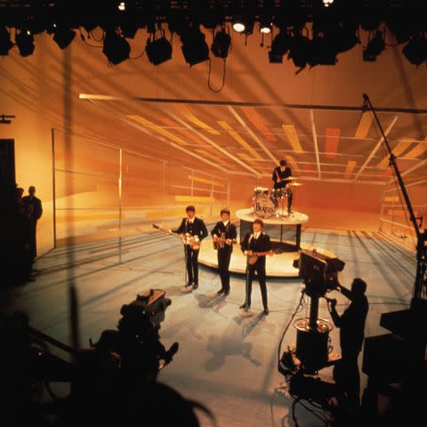 <p>Bettmann Archive/Getty</p> The Beatles perform on the Ed Sullivan Show, Feb. 9 1964