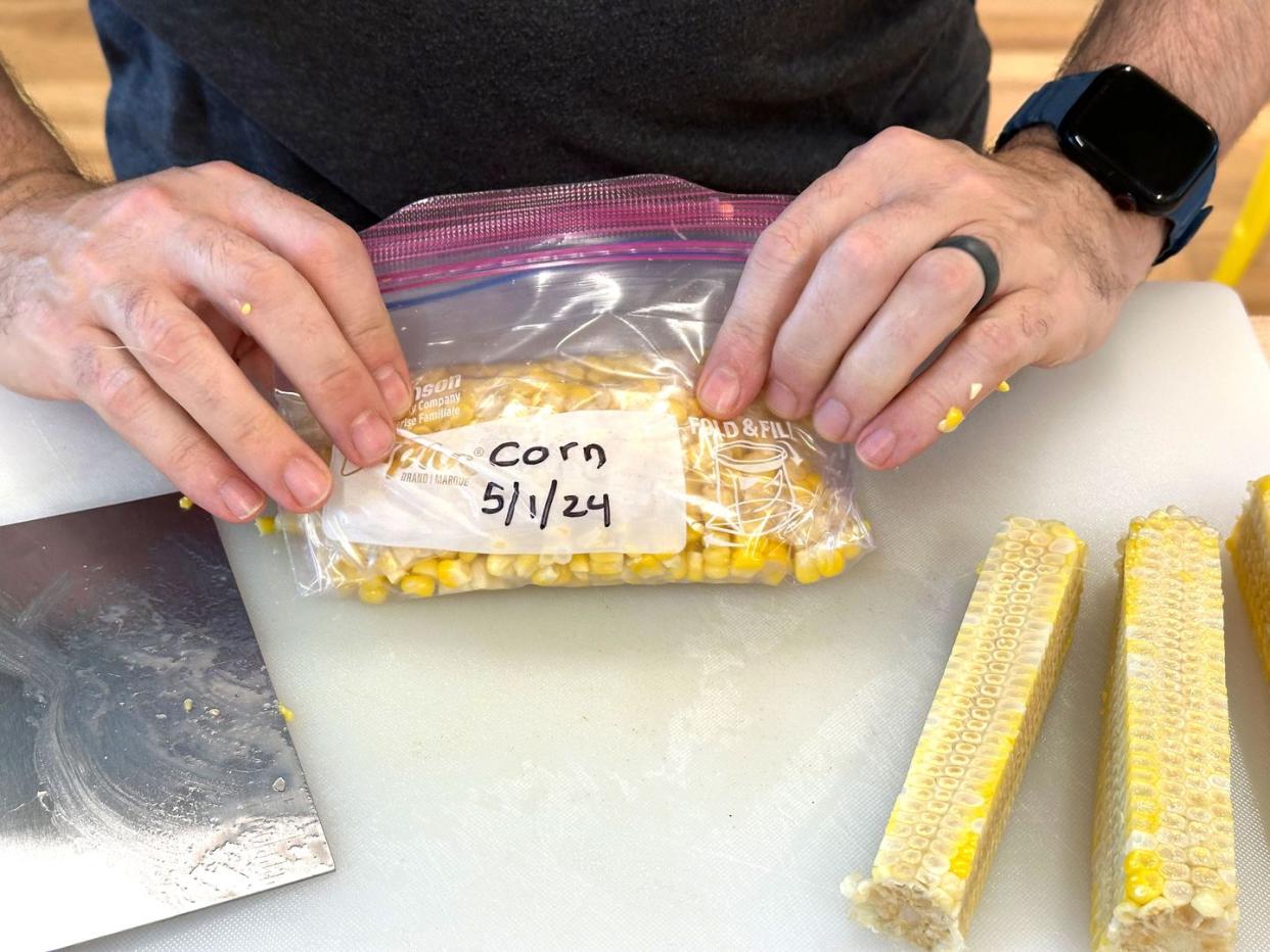 a person putting cheese on a sandwich