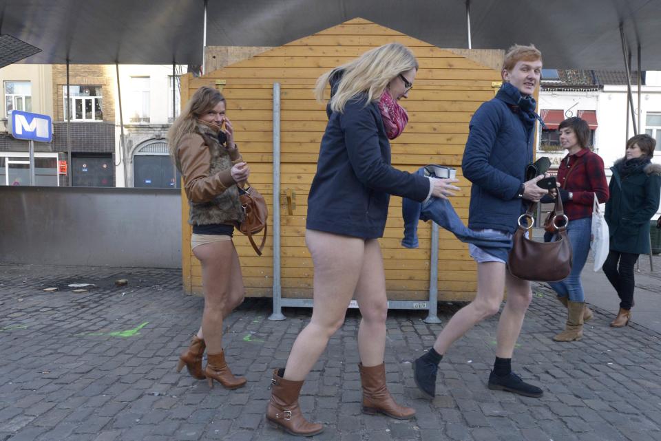 People take part in the annual "No Pants Subway Ride" celebrations on the streets of Brussels January 12, 2014. The event involves participants who strip down to their underwear as they go about their normal routine, and occurs in different cities around the world in January, according to its organisers. REUTERS/Eric Vidal (BELGIUM - Tags: TRANSPORT SOCIETY ANNIVERSARY)