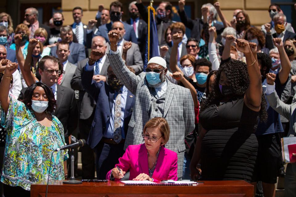 On June 12 at the Iowa Capitol, Gov. Kim Reynolds signs bipartisan legislation banning most police chokeholds and addressing officer misconduct. Protesters and other civil rights advocates had demanded legislation to address police violence. The Legislature introduced and approved the bill and the governor signed it in the span of two days.