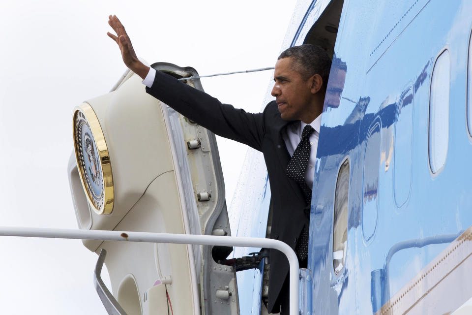 President Barack Obama waves as he boards Air Force One at Andrews Air Force Base, Md., Wednesday, Feb. 26, 2014, en route to St. Paul, Minn. In Minnesota he is expected to speak at Union Depot rail and bus station with a proposal asking Congress for $300 billion to update the nation's roads and railways, and about a competition to encourage investments to create jobs and restore infrastructure as part of the President’s Year of Action. (AP Photo/Jacquelyn Martin)
