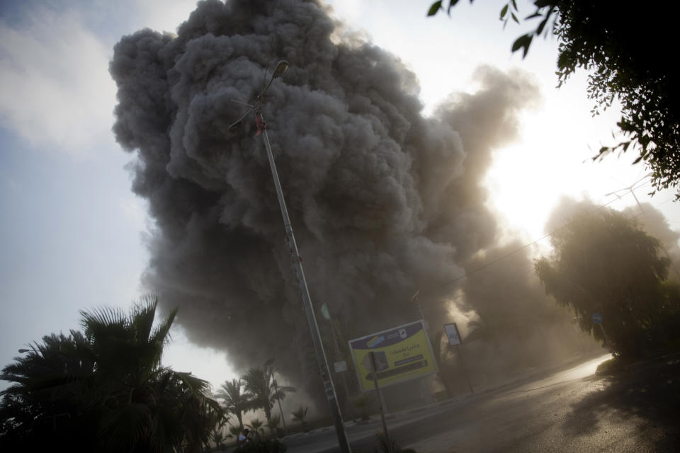 FILE - In this July 14, 2018 file photo, smoke rises following an Israeli airstrike that hit a government building in Gaza City. Hamas officials say Egypt is trying to broker a broad new cease-fire deal between Gaza’s ruling group and Israel to pave the way for Gaza's reconstruction and an eventual prisoner swap. Repeated cease-fire deals over the years collapsed, but there were signs Thursday, Aug. 2, 2018, of possible momentum toward a new agreement, after weeks of escalation between Israel and Hamas. (AP Photo/Khalil Hamra, File)