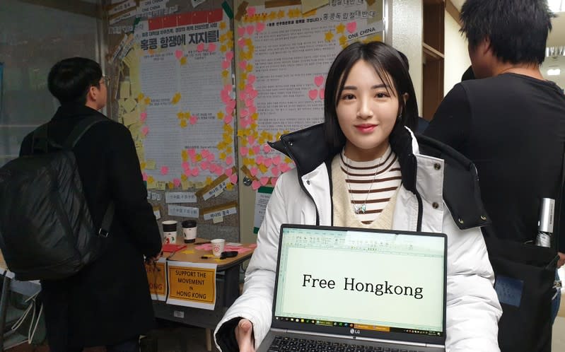 A university student Kang Min-seo poses for photographs in front of a poster supporting Hong Kong protesters at a university in Seoul