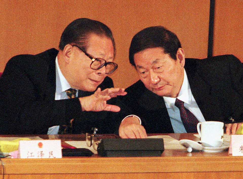 FILE - In this March 5, 1999, file photo, then Chinese President Jiang Zemin, left, talks with then Premier Zhu Rongji during the second plenary session of the National People's Congress in Beijing's Great Hall of the People. Chinese state TV said Wednesday, Nov. 30, 2022, that Jiang has died at age 96. (AP Photo/Eugene Hoshiko, File)