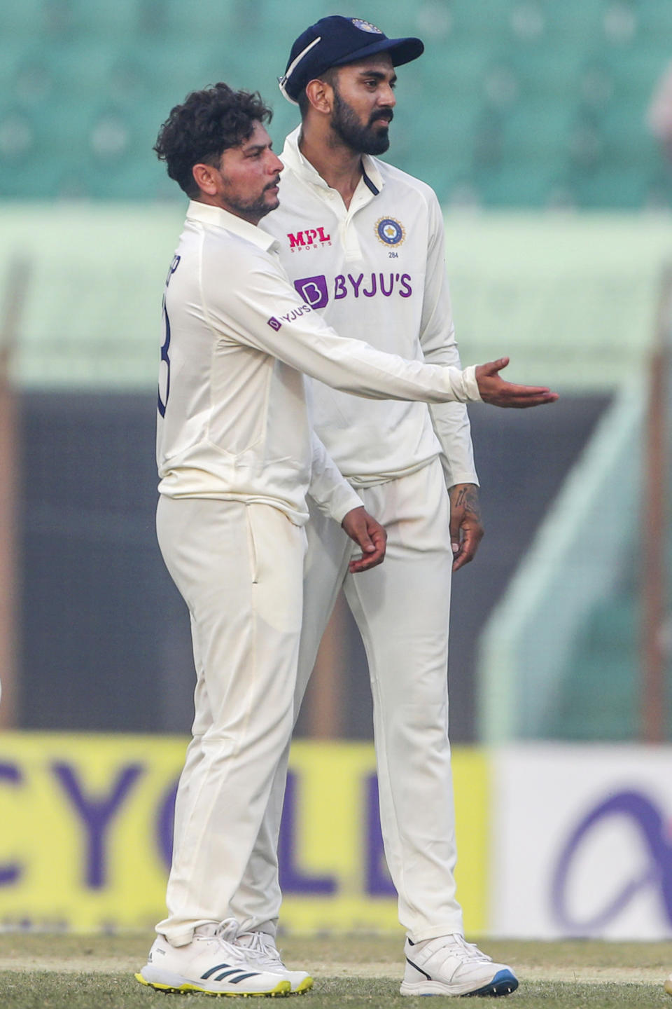 India's Kuldeep Yadav, left and captain K.L Rahul celebrate the wicket of Bangladesh's Nurul Hasan during the second day of the first test cricket match between Bangladesh and India in Chattogram, Bangladesh, Thursday, Dec. 15, 2022. (AP Photo/Surjeet Yadav)