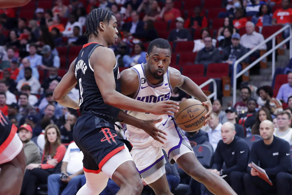 Sacramento Kings forward Harrison Barnes, right, drives into Houston Rockets guard Josh Christopher, left, during the first half of an NBA basketball game, Monday, Feb. 6, 2023, in Houston. (AP Photo/Michael Wyke)