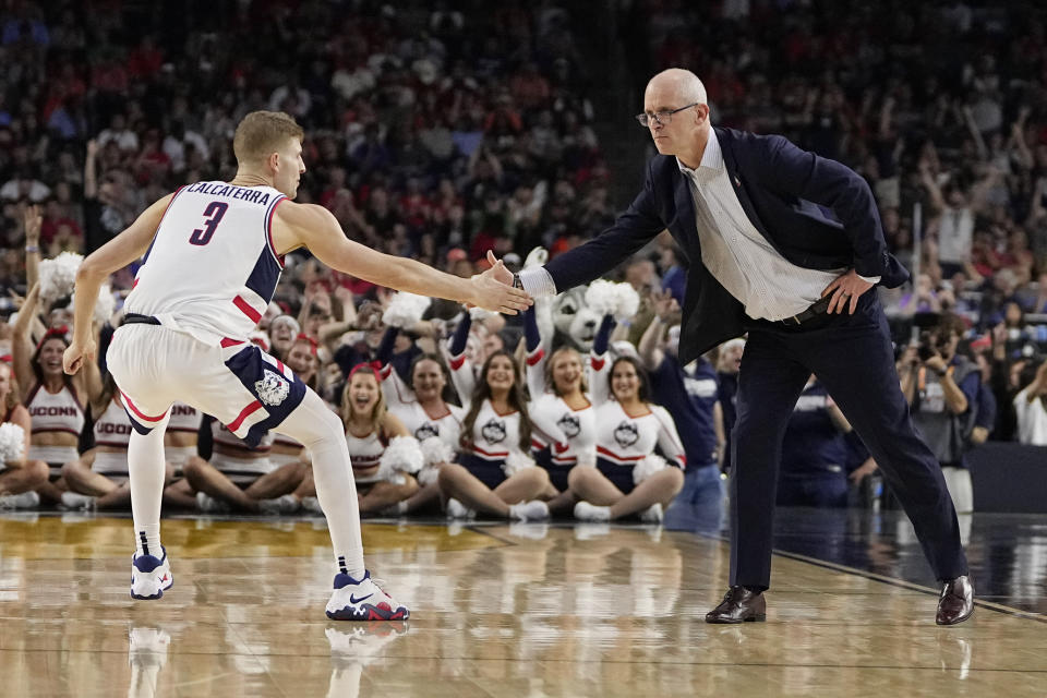 Connecticut head coach Dan Hurley celebrates with guard Joey Calcaterra during the first half of a Final Four college basketball game against Miami in the NCAA Tournament on Saturday, April 1, 2023, in Houston. (AP Photo/David J. Phillip)