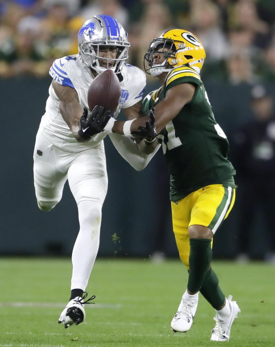 Lions wide receiver Josh Reynolds catches a pass against the defense of Packers cornerback Carrington Valentine during the Lions' 34-20 win on Thursday, Sept. 28, 2023, in Green Bay, Wisconsin.