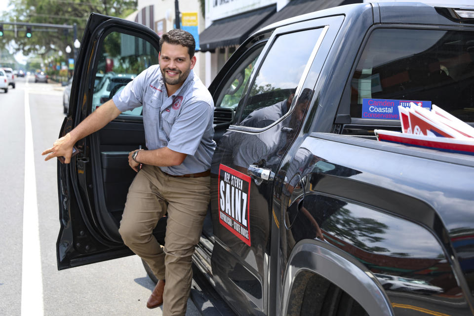 Georgia Republican state Rep. Steven Sainz steps out of his truck during campaigning in Kingsland, Ga., Tuesday, June 11, 2024. Sainz said he thinks his opponent's use of artificial intelligence “hides behind what amounts to a robot instead of authentically communicating his opinions to voters. ... I’m not running on artificially generated promises, but real world results,” adding that he isn’t using AI in his own campaign. (AP Photo/Gary McCullough)