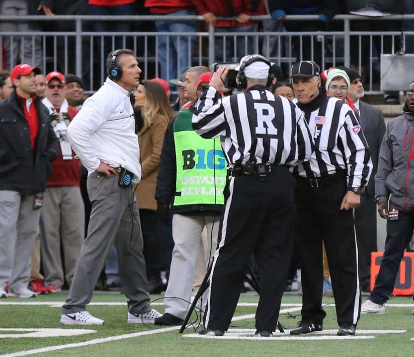 FILE – Officials review a fourth down spot as Ohio State head coach Urban Meyer paces the sidelines during overtime of an NCAA college football game against Michigan, Saturday, Nov. 26, 2016, in Columbus, Ohio. Ohio State beat Michigan 30-27 in double overtime. (Don Speck/The Lima News via AP, File)