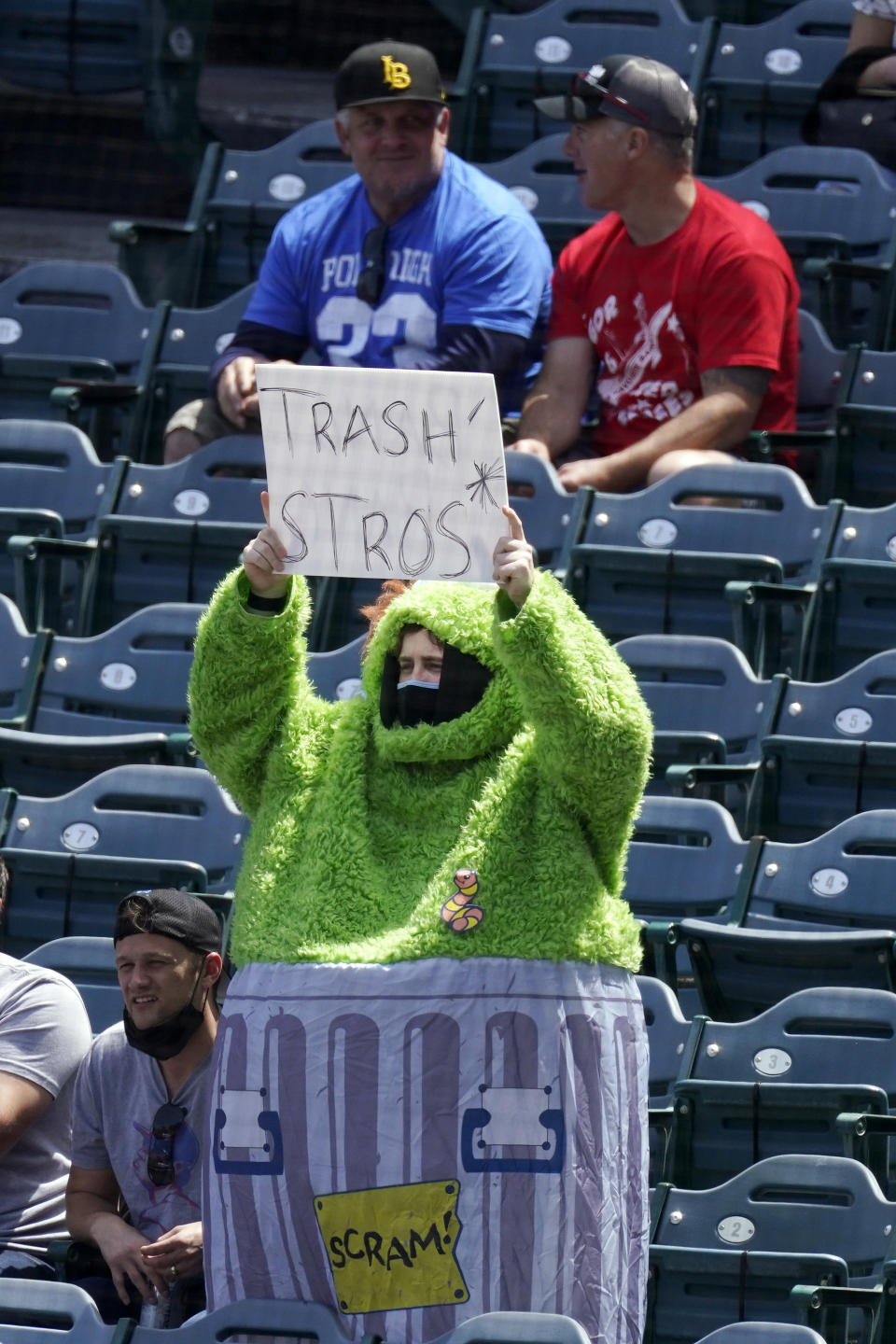 ADDS FULL NAME OF COSTUME - A fan wears an Oscar the Grouch costume as he taunts the Houston Astros prior to a baseball game against the Los Angeles Angels Tuesday, April 6, 2021, in Anaheim, Calif. (AP Photo/Mark J. Terrill)