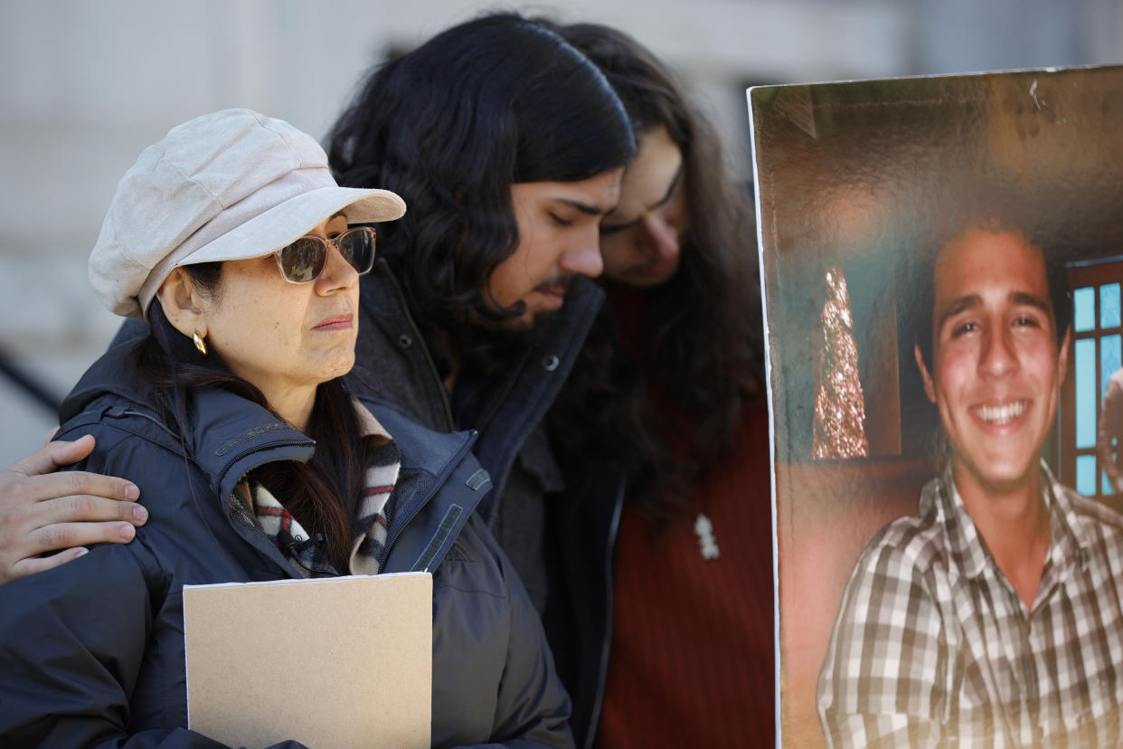 Belkis Terán, left, Daniel Paez, center, and Pedro Terán, family members of Manuel Esteban Paez Terán, right, embrace during a press conference, Monday, March 13, 2023, in Decatur, Ga. A press conference was held to give additional autopsy findings in Terán's death. (AP Photo/Alex Slitz)