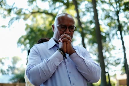 Verrandall Tucker pauses while visiting gravesite in Tucker family cemetery in Hampton, Virginia