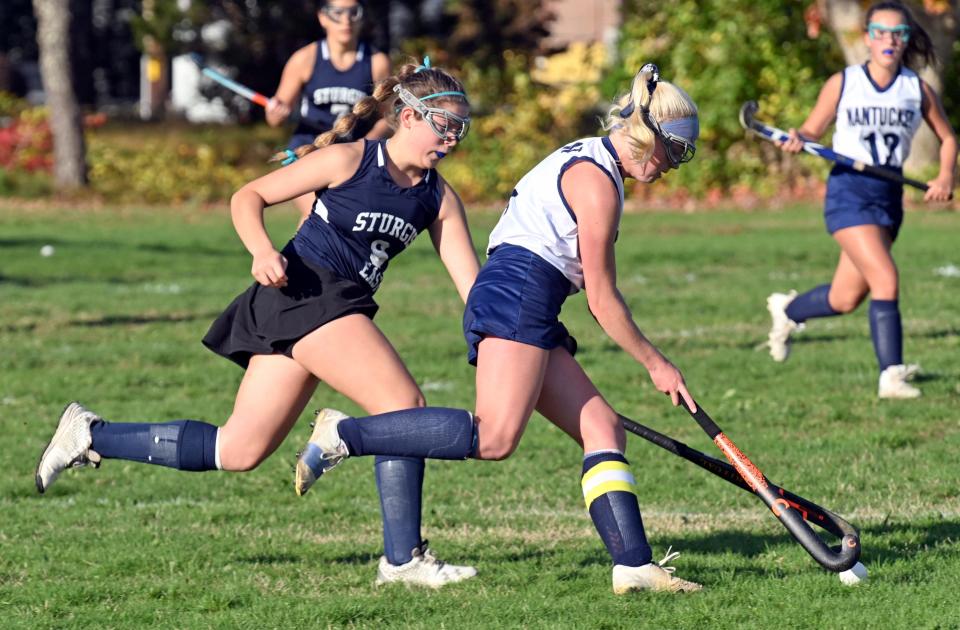 Caroline Allen of Nantucket pushes the ball ahead of Molly Reino of Sturgis East last year in South Yarmouth.