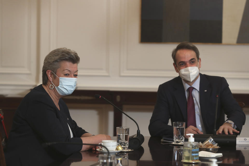 European Commissioner for Home Affairs Ylva Johansson, left, speaks with Greek Prime Minister Kyriakos Mitsotakis, during their meeting in Athens , on Tuesday , March 30, 2021. Johansson stressed the need for solidarity among the bloc's member states in tackling migration, and called on Turkey to resume accepting the return of people whose asylum applications are rejected in Greece after arriving from Turkey. (AP Photo/Petros Giannakouris)