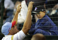 FILE - Former major leaguer Dante Bichette, left, talks with his son Bo Bichette, 7, in the stands before coaching his older son Dante Bichette Jr.'s little league team representing Maitland, Fla., against Davenport, Iowa at the Little League World Series in South Williamsport, Pa., Friday, Aug. 19, 2005. In all, more than two dozen major league offspring are on AL or NL rosters this year. The Blue Jays alone have three, including the sons of Hall of Famers Craig Biggio (Cavan) and Vladimir Guerrero (Vlad Jr.), along with Bo Bichette, whose father, Dante, was a four-time All-Star with the Rockies. (AP Photo/Gene J. Puskar, File)