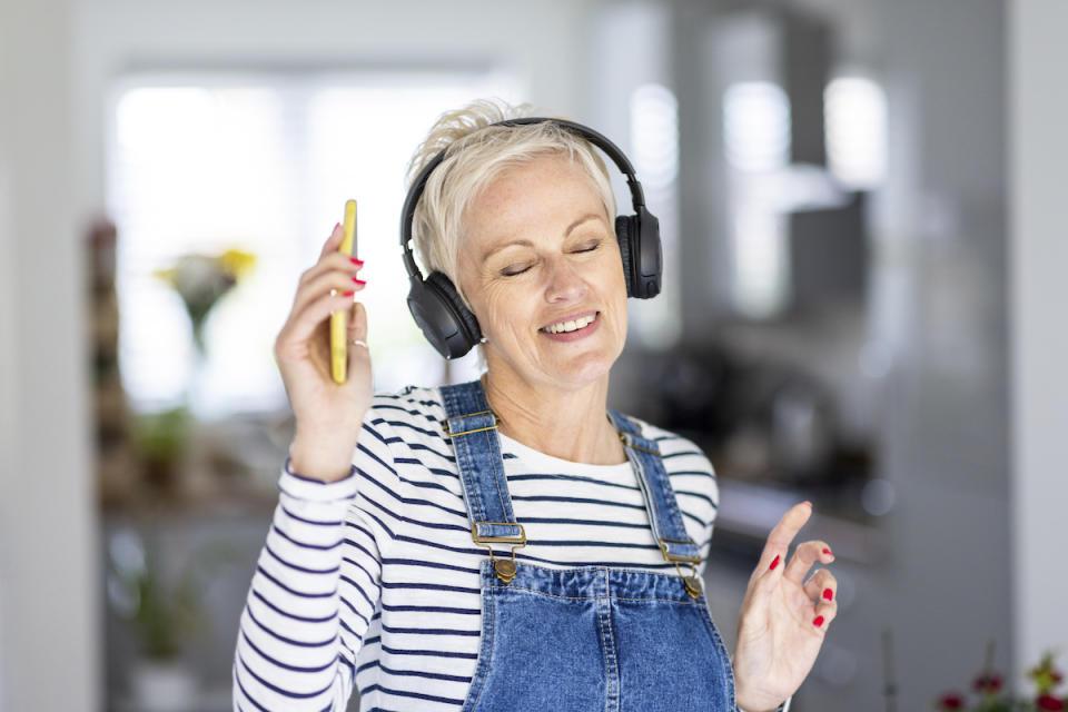 Woman listening to music and smiling