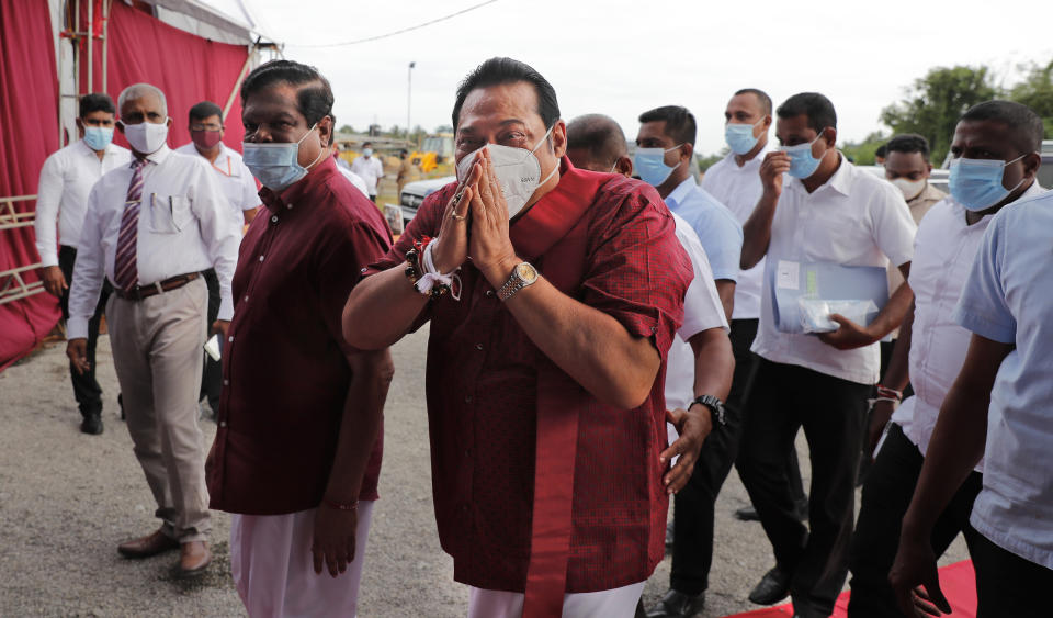 Sri Lankan Prime Minister and older brother of the country's current president Mahinda Rajapaksa, center, greets supporters during an election rally in Colombo, Sri Lanka, July 22, 2020. Sri Lankans are voting Aug. 5 in parliamentary elections that are expected to strengthen President Gotabaya Rajapaksa's grip on power. More than 16 million people are eligible to vote to elect 196 out of a total of 225 lawmakers. The others will be named from a national list according to the number of votes received by each party or independent group. (AP Photo/Eranga Jayawardena)