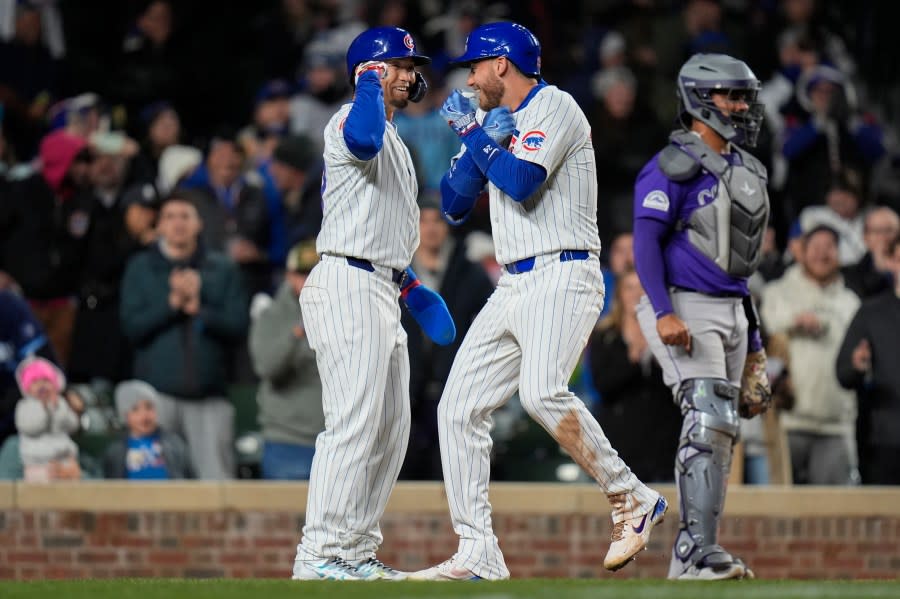 Chicago Cubs' Cody Bellinger, right, and Seiya Suzuki celebrate Bellinger's two-run home run during the seventh inning of a baseball game against the Colorado Rockies, Tuesday, April 2, 2024, in Chicago. (AP Photo/Erin Hooley)