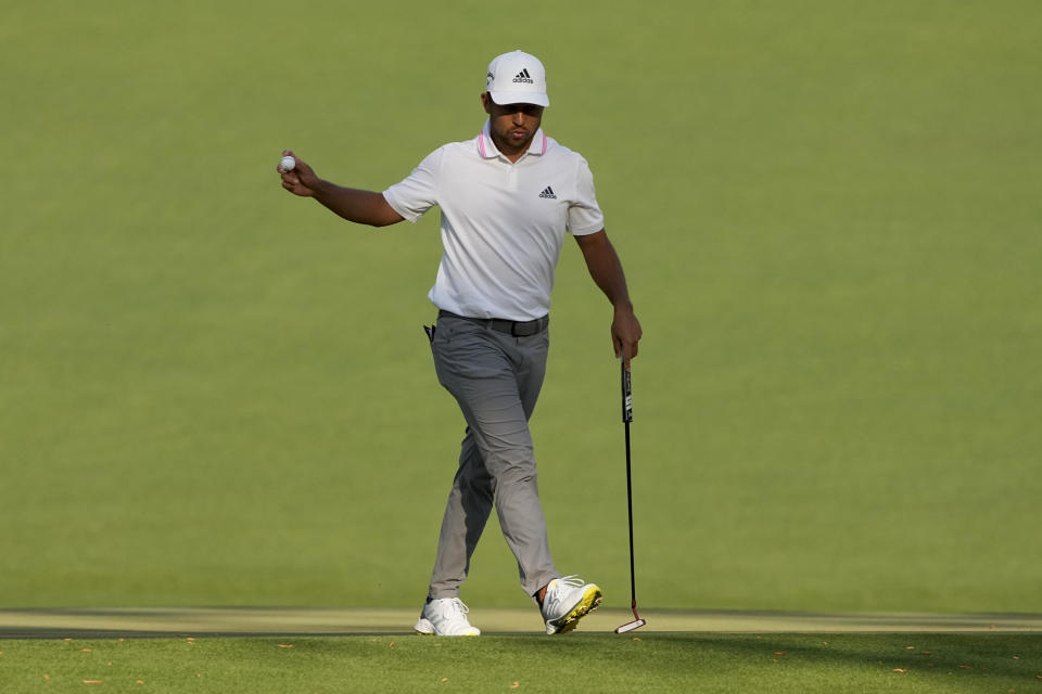 Xander Schauffele holds up his ball after a birdie on the 15th hole during the final round of the Masters golf tournament on Sunday, April 11, 2021, in Augusta, Ga. (AP Photo/Charlie Riedel)