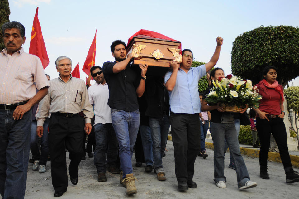 FILE - In this Feb. 5, 2015, file photo, friends and relatives of land activist Alejandro Salgado Delgado carry his coffin during a funeral procession in Cuernavaca, Mexico. Police detained four men suspected of involvement in the killing of Salgado, a land rights activist from the state of Morelos. Global Witness said Tuesday, July 24, 2018 that at least 207 people who were protecting land and resources from business interests were slain last year. (AP Photo/Tony Rivera, File)