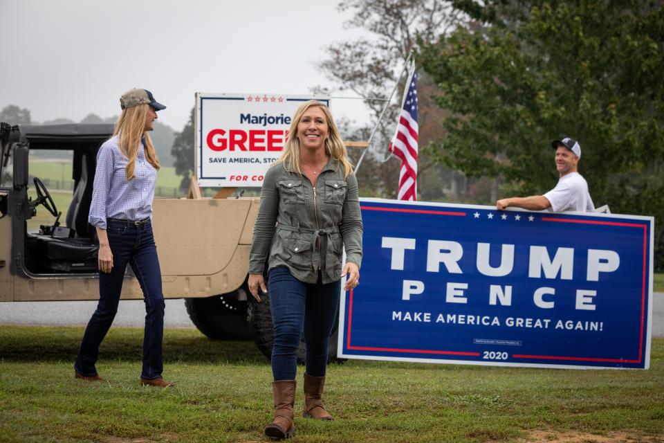 Republican Senator Kelly Loeffler and Republican House candidate Marjorie Taylor Greene, who has expressed support for QAnon, campaign in Georgia on 15 October.Getty Images