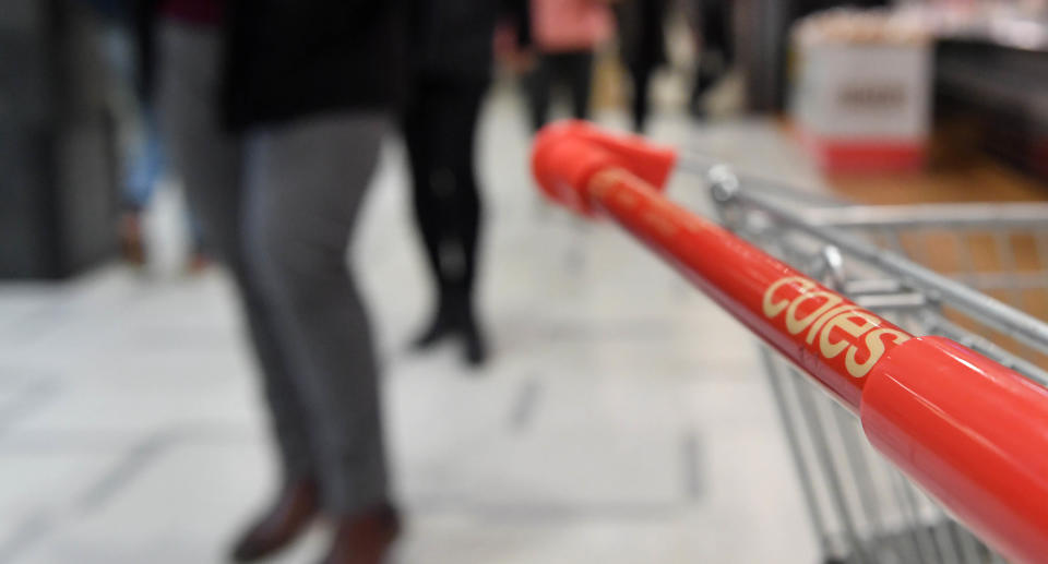 Office workers walk past a Coles supermarket in Sydney, Wednesday, April 28, 2021. Source: AAP