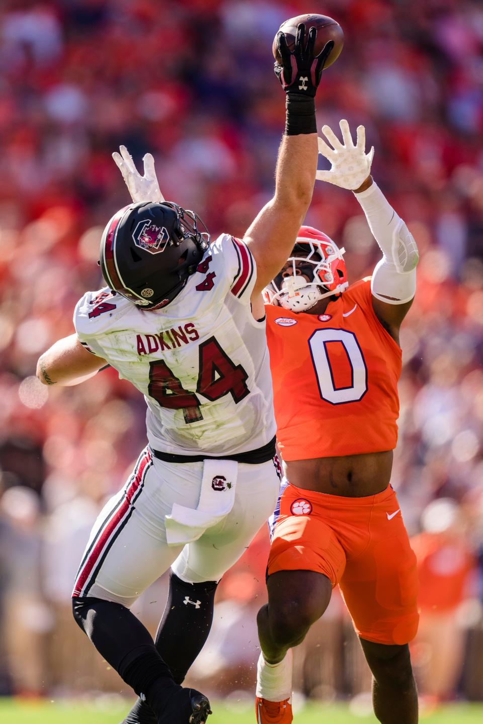 South Carolina tight end Nate Adkins (44) makes a catch while covered by Clemson linebacker Barrett Carter.