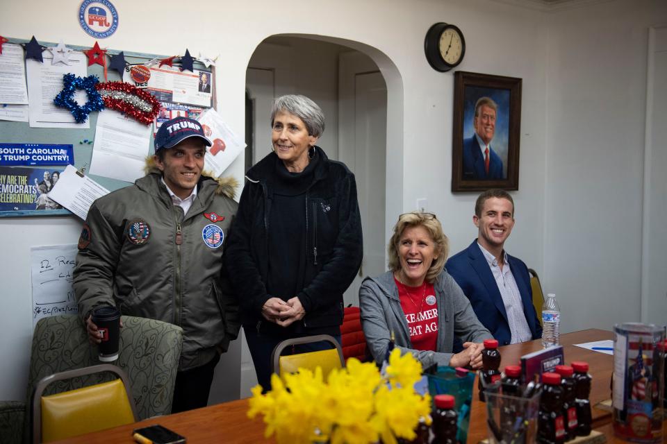 From left, Roman Bisser, 29, Harriet Morrow, 59, Cat Callahan, 60, and Griffin Callahan, 26, watch the Republican presidential primary election results during a watch party at the Greenville County Republican Party headquarters in Greenville, S.C., on Saturday, Feb. 24, 2024.