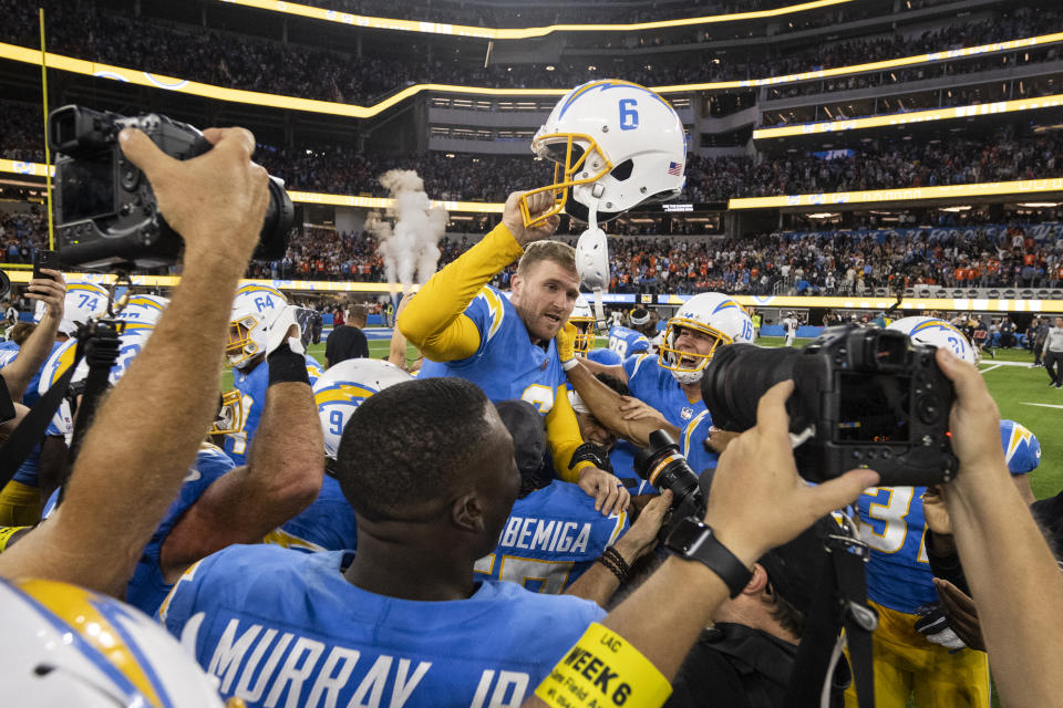 Los Angeles Chargers players hoist place kicker Dustin Hopkins (6) after his kick wins the game against the Denver Broncos in overtime in an NFL football game, Monday, Oct. 17, 2022, in Inglewood, Calif. Chargers won 19-16. (AP Photo/Kyusung Gong)