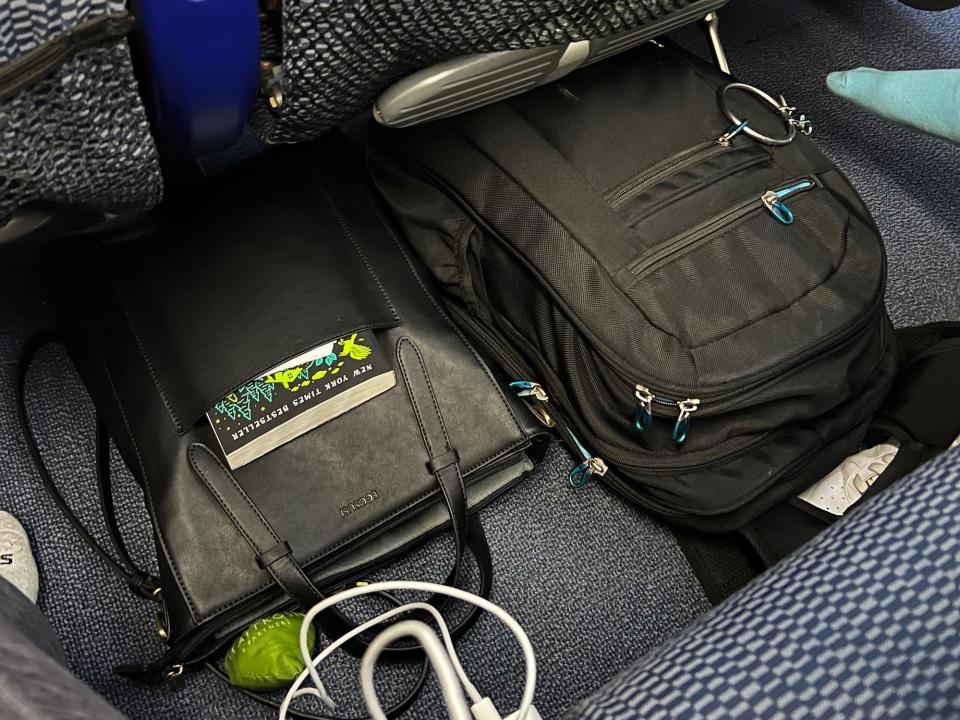 Two black backpacks under the seat.