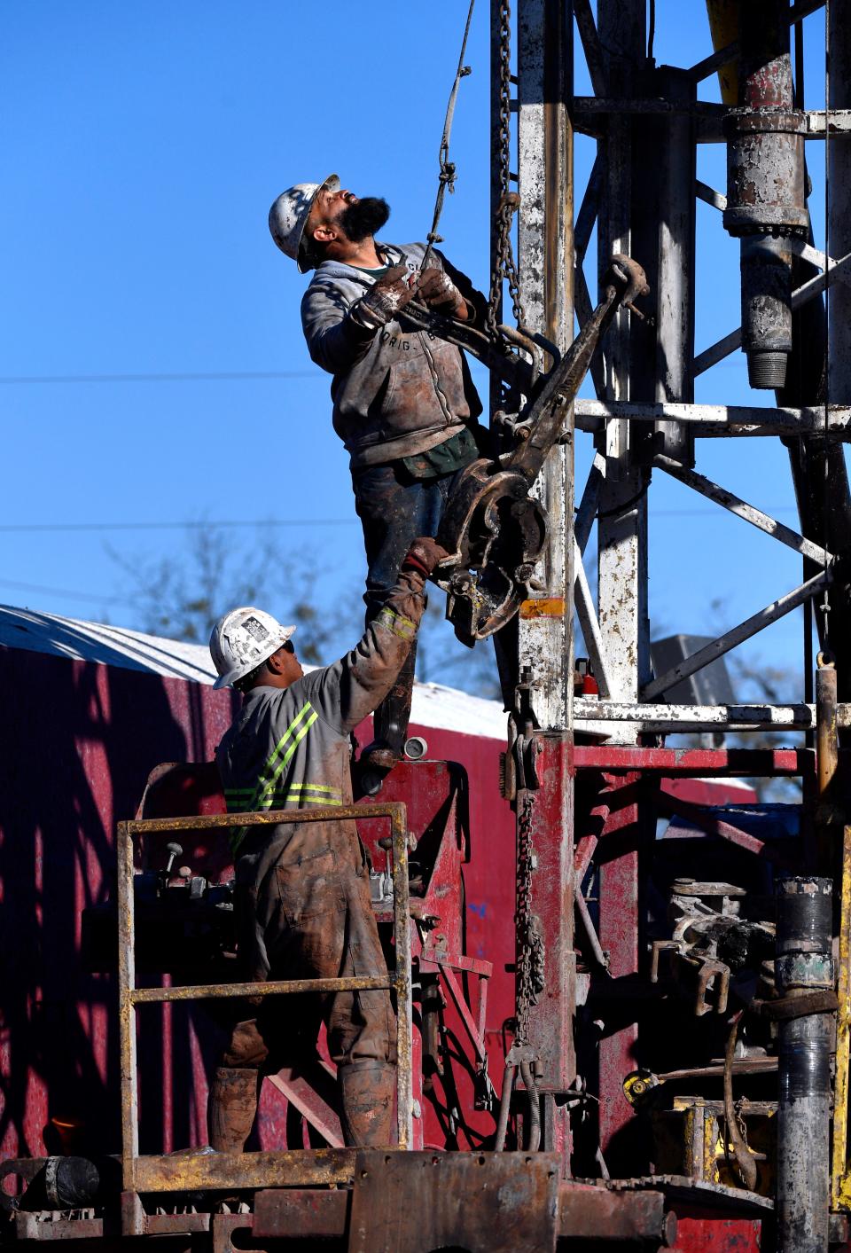 Men work on the Burger St. oil drilling rig Jan. 5.