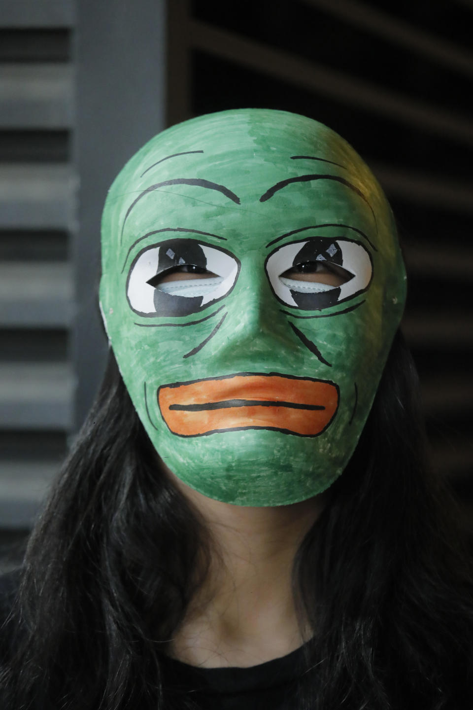 A protester wears a mask forming a human chain during a protest in Hong Kong, Friday, Oct. 18, 2019. Hong Kong protesters masqueraded as various characters in defiance of a government ban on face coverings at public gatherings. (AP Photo/Kin Cheung)