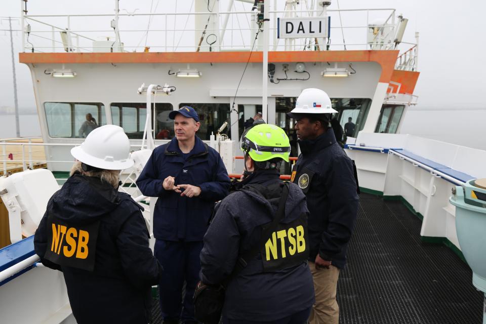 NTSB and U.S. Coast Guard investigators are seen March 27, 2024, on the cargo vessel Dali, which struck and collapsed the Francis Scott Key Bridge on March 26, 2024.
