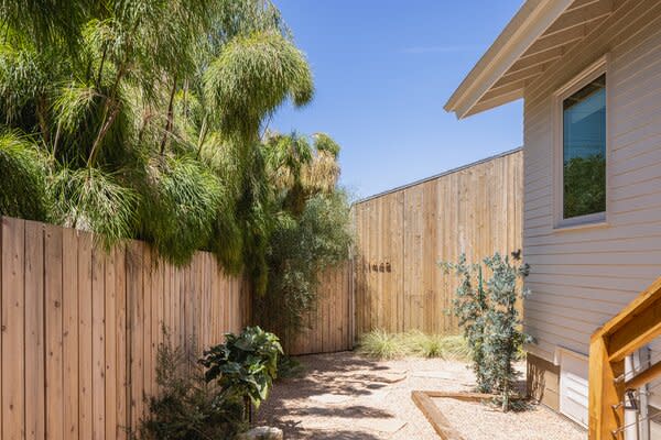 A gravel path with flagstone leads to the new ADU at the rear of the house. "We wanted everything to feel as natural as possible,