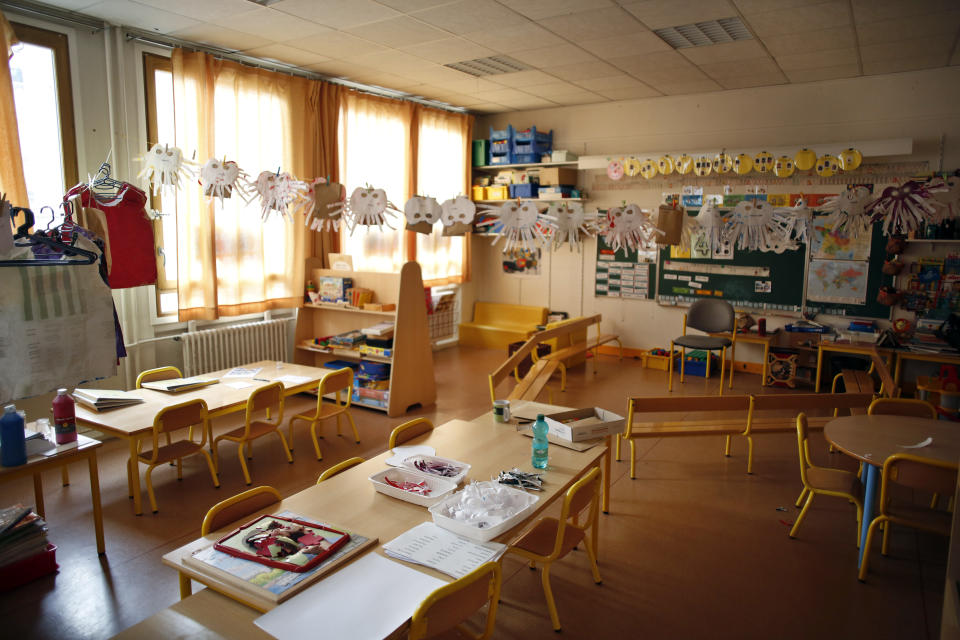 An empty classroom is seen at a closed school in Paris, Monday, March 16, 2020. France plans to close all creches, schools and universities from Monday until further notice to limit the spread of the novel coronavirus, President Emmanuel Macron says. For most people, the new coronavirus causes only mild or moderate symptoms. For some it can cause more severe illness, especially in older adults and people with existing health problems. (AP Photo/Thibault Camus)