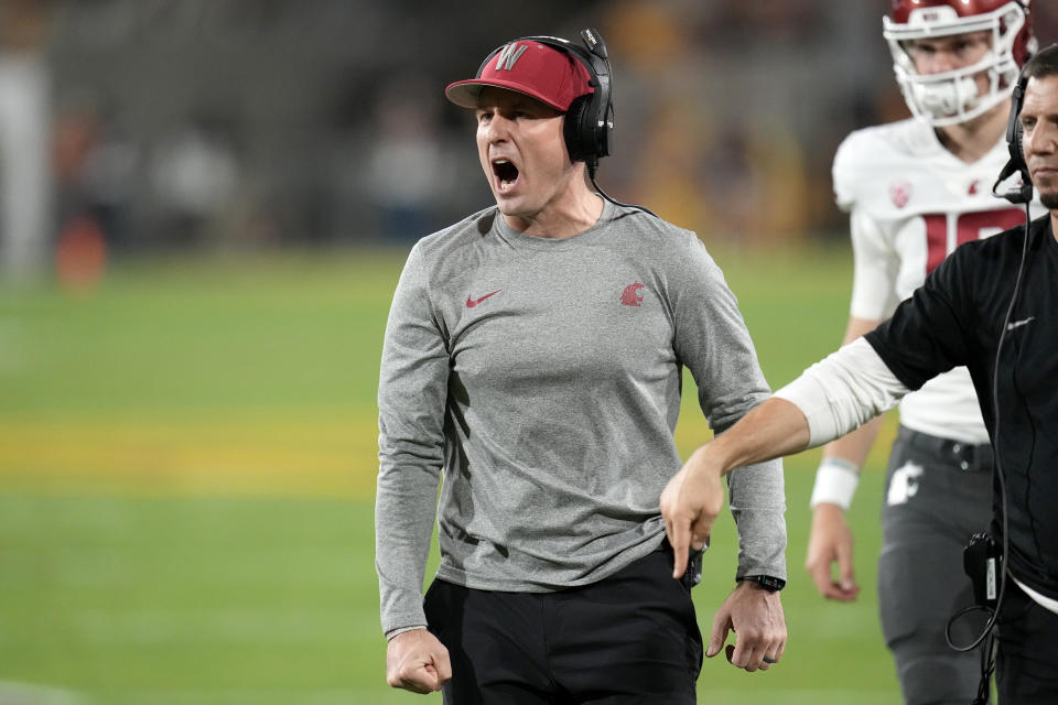 Washington State head coach Jake Dickert, left, shouts after a touchdown by his team against Arizona State during the first half of an NCAA college football game Saturday, Oct. 28, 2023, in Tempe, Ariz. (AP Photo/Ross D. Franklin)