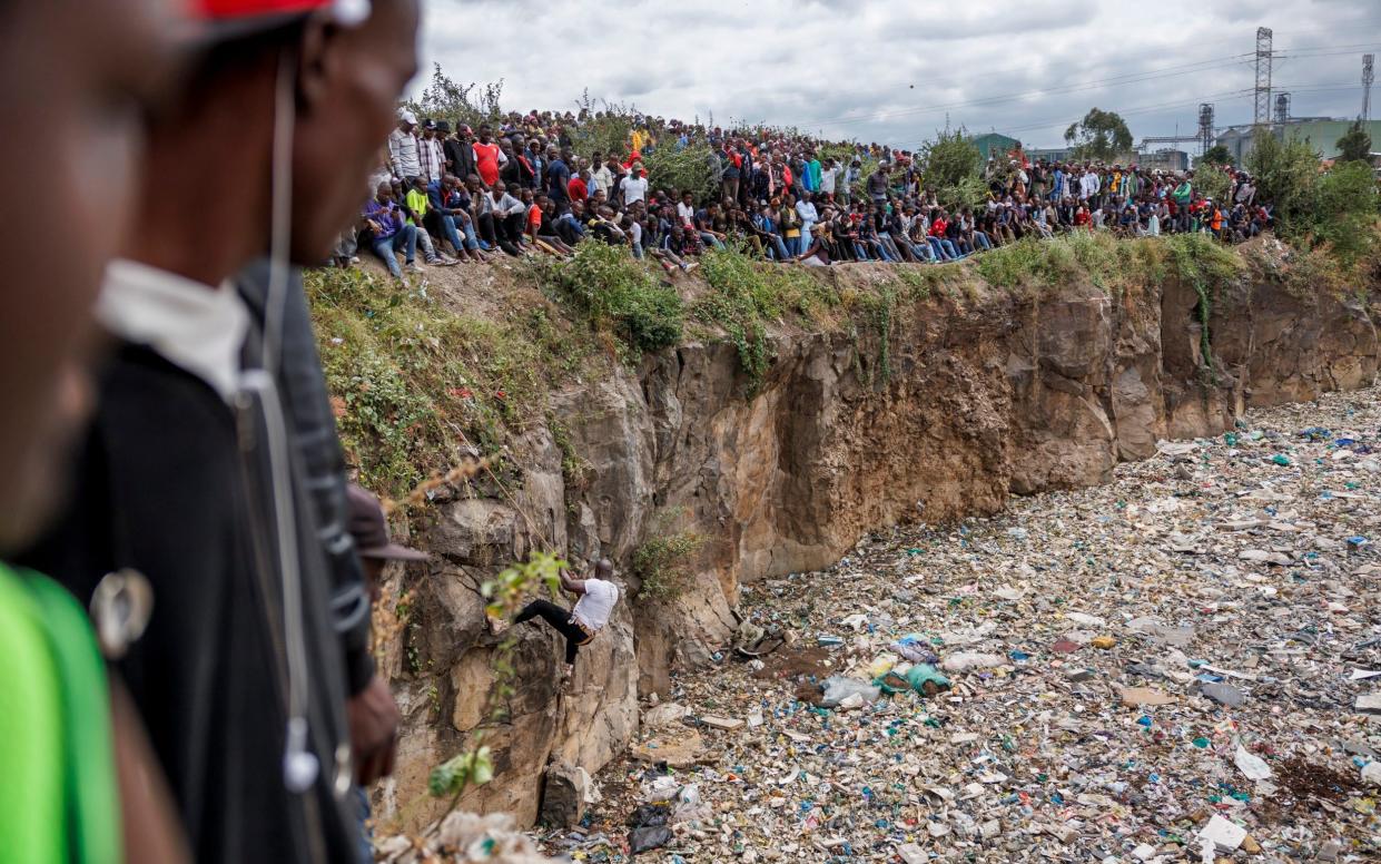 Crowds gather on the edge of the former quarry