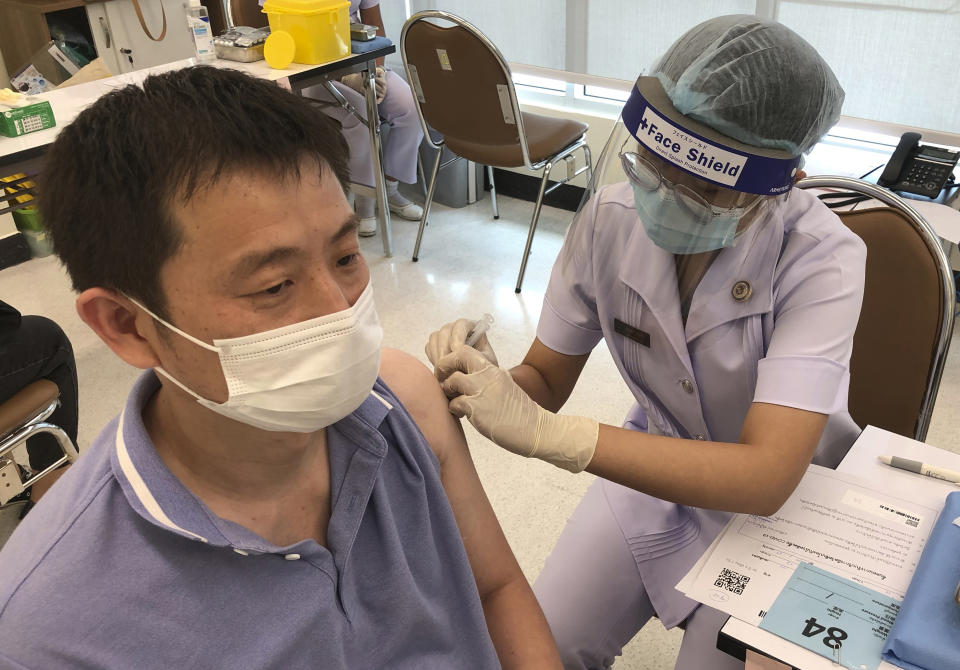 A health worker administers a dose of the Sinovac COVID-19 vaccine to Zhang Xiaohong, a 40-year-old businessman who runs a logistic company in Thailand, at Bangrak Vaccination and Health Center in Bangkok, Thailand Thursday, May 20, 2021. China began vaccinating its citizens living in Thailand on Thursday as part of a global campaign to inoculate its nationals living and working abroad. (AP Photo/Fu Ting)