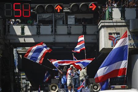 Anti-government protesters wave Thai national flags as they take part in a rally in central Bangkok January 30, 2014. REUTERS/Athit Perawongmetha