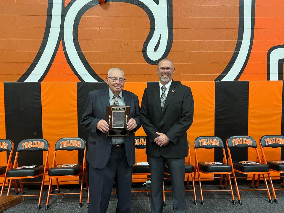 Allen Gaskill received a plaque from Newcomerstown Schools Superintendent Jason People, as he is the newest member of the high school's wall of honor.