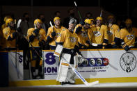 Nashville Predators goaltender Pekka Rinne (35) smiles as he receives a standing ovation from the crowd and his teammates after the Predators beat the Carolina Hurricanes in an NHL hockey game Monday, May 10, 2021, in Nashville, Tenn.(AP Photo/Mark Zaleski)