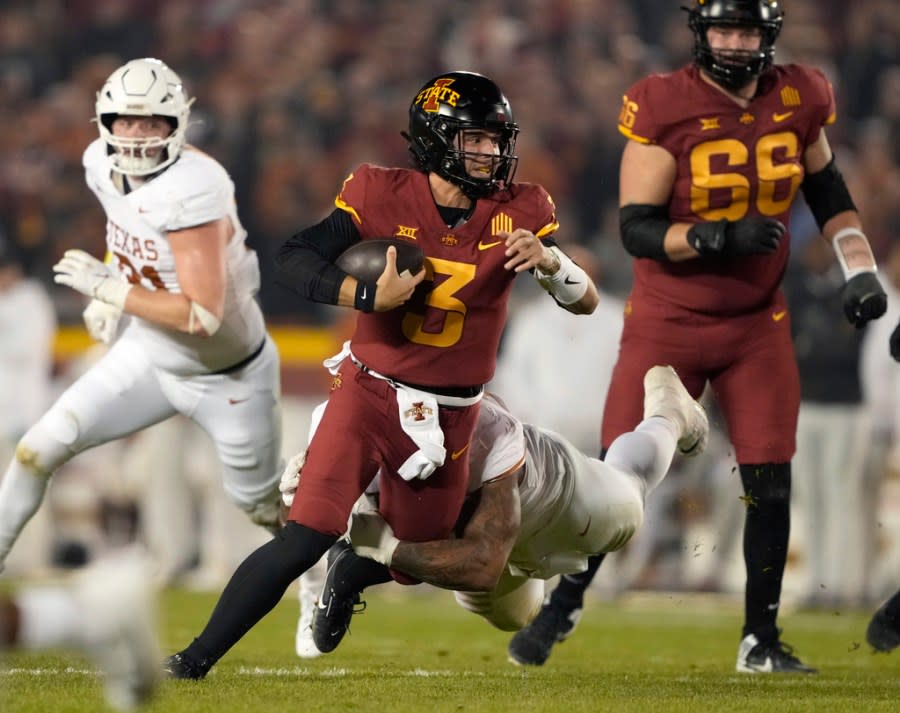 Iowa State quarterback Rocco Becht (3) is sacked by Texas defensive lineman Byron Murphy, bottom center, during the first half of an NCAA college football game, Saturday, Nov. 18, 2023, in Ames, Iowa. (AP Photo/Matthew Putney)